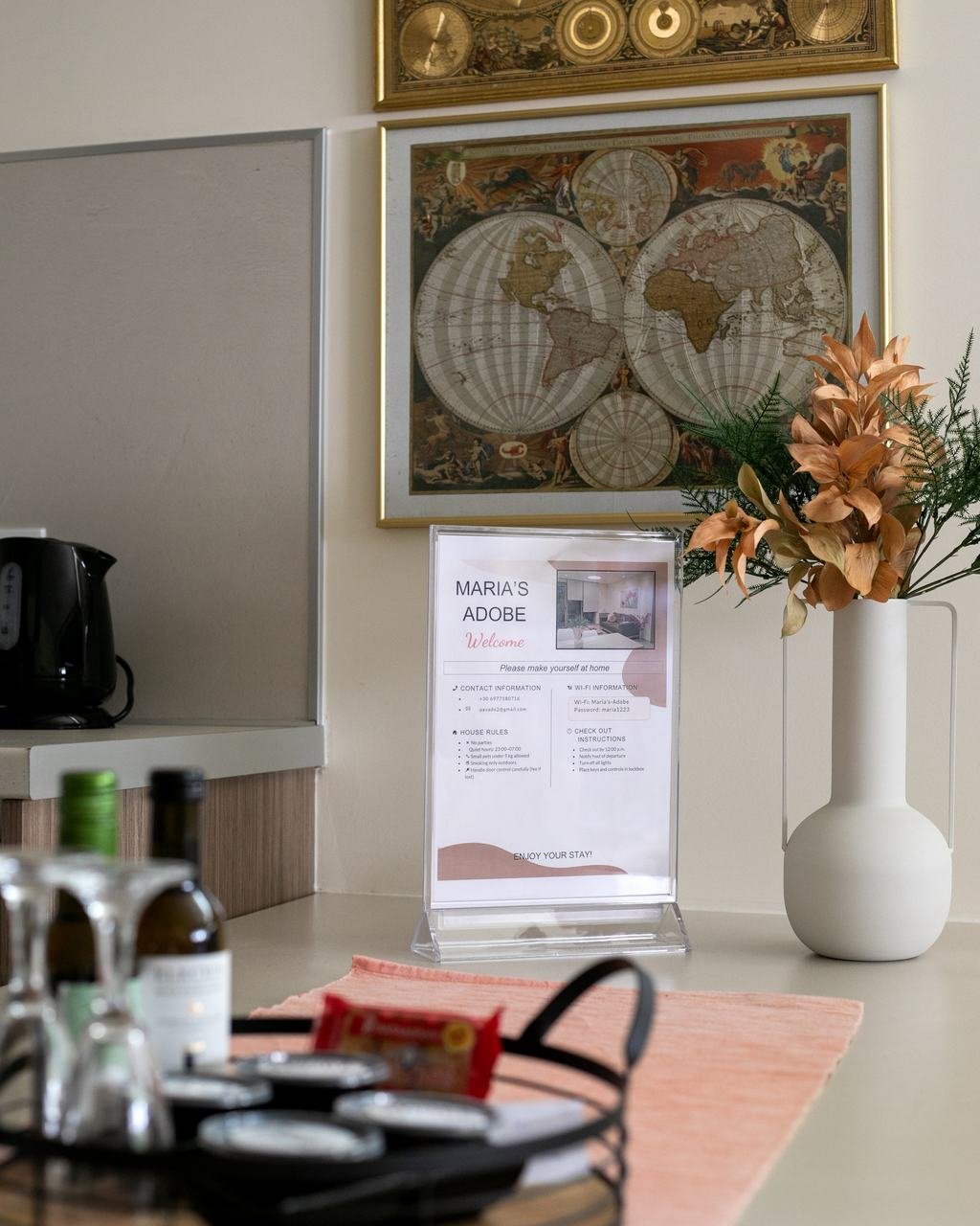 Welcome tray with wine, glasses and snacks on the dining table