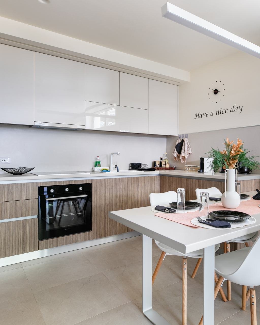 Wood and white kitchen with a dining table set for four