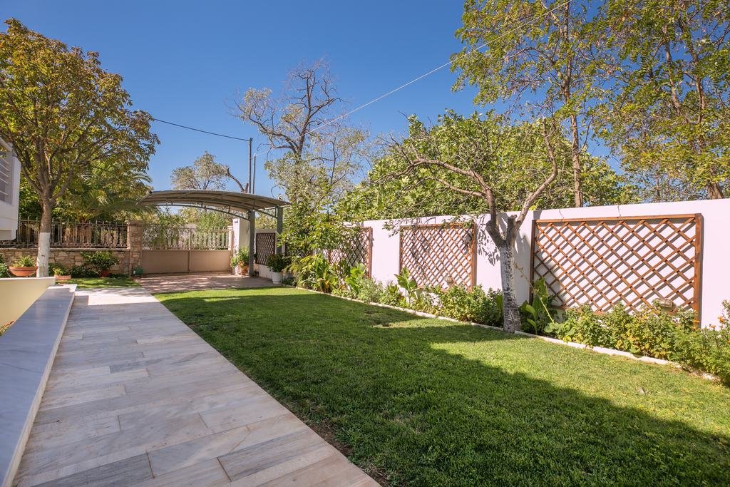 Marble path along the lawn leading to the garden gate